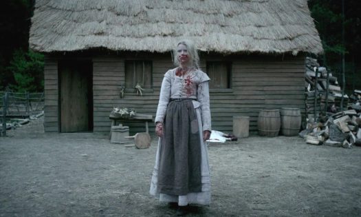 alt ="bloody young girl in front of hut"